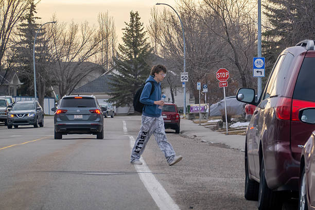 Person walking home along a suburban street at evening
