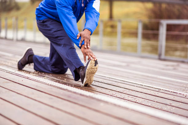 Person stretching safely outdoors with proper footwear
